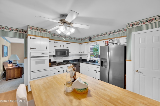 1223 Clover Rd, Brick, NJ 08724 - kitchen featuring appliances with stainless steel finishes, a sink, a warming drawer, wallpapered walls, and ceiling fan