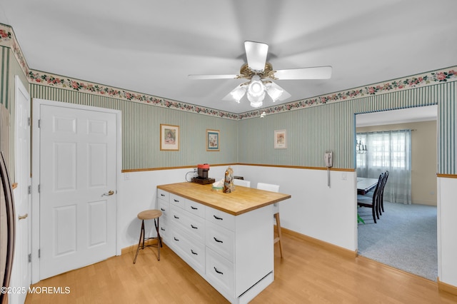 1223 Clover Rd, Brick, NJ 08724 - kitchen featuring wooden counters, white cabinets, light wood-style floors, wallpapered walls, and a ceiling fan