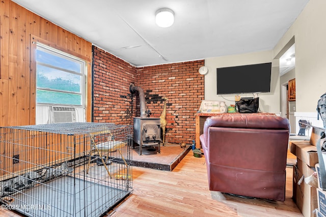 211 Long Swamp Rd, New Egypt, NJ 08533 - living room featuring wood finished floors, a wood stove, cooling unit, and wooden walls