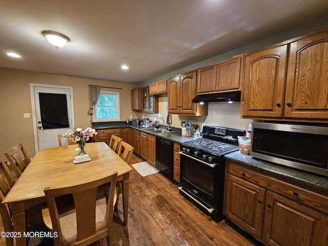 211 Long Swamp Rd, New Egypt, NJ 08533 - kitchen featuring black appliances, under cabinet range hood, a sink, dark wood-type flooring, and dark countertops