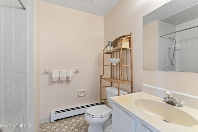 bathroom featuring a baseboard heating unit, toilet, vanity, and baseboards