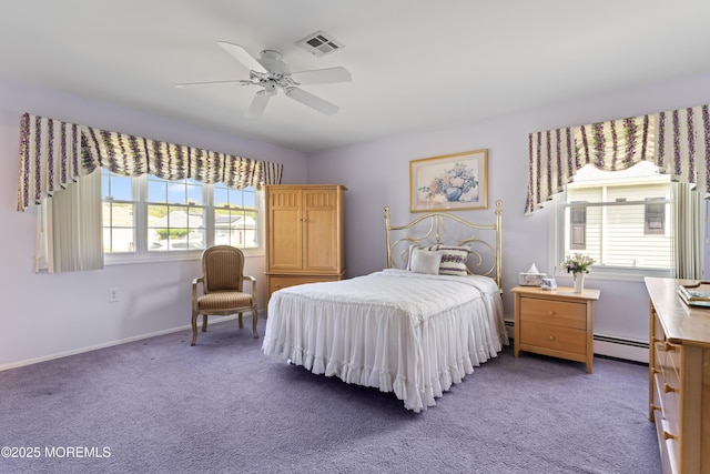 carpeted bedroom featuring a baseboard radiator, a ceiling fan, and baseboards