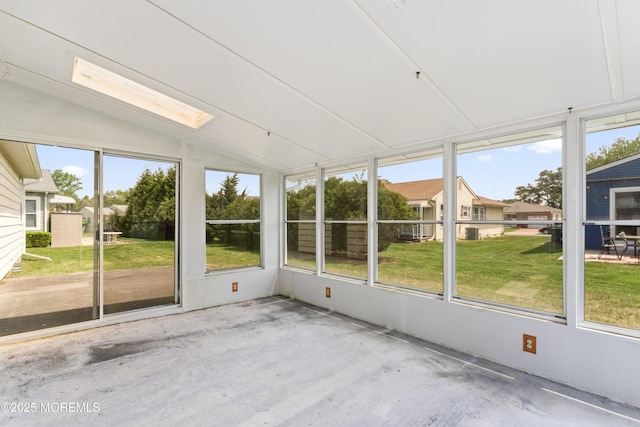 unfurnished sunroom featuring vaulted ceiling