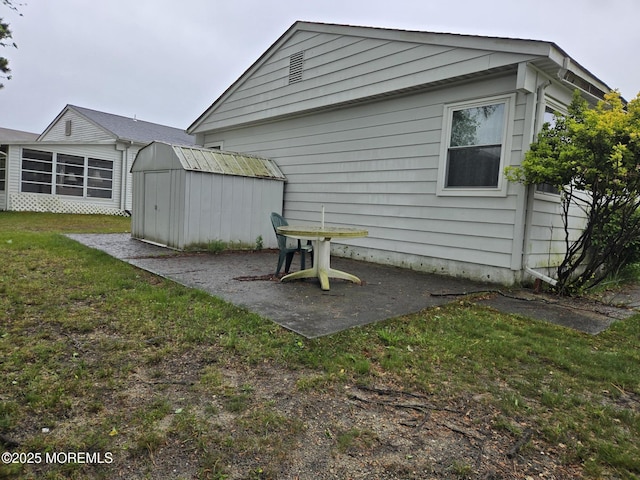 15 Roxton Pl, Toms River, NJ 08757 - back of property featuring a storage shed, a patio, an outbuilding, and a lawn