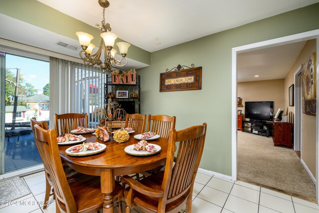 3 Romero Ct, Monroe, NJ 08831 - dining area featuring a chandelier, light tile patterned flooring, light carpet, and baseboards