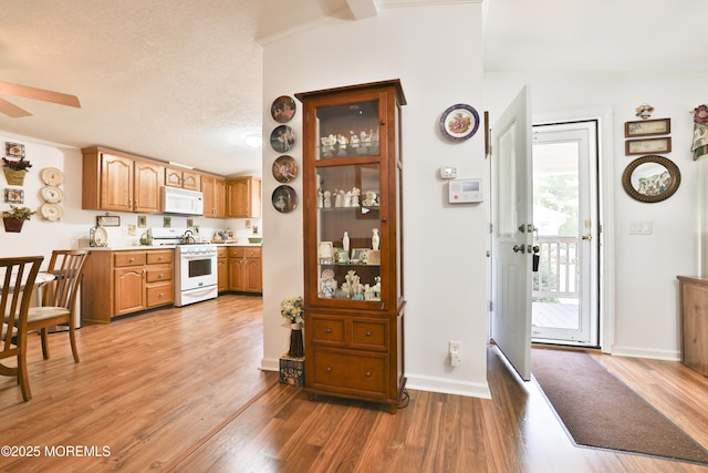 39 Goldenrod Pl, Jackson, NJ 08527 - kitchen with white appliances, ceiling fan, light countertops, light wood-type flooring, and vaulted ceiling