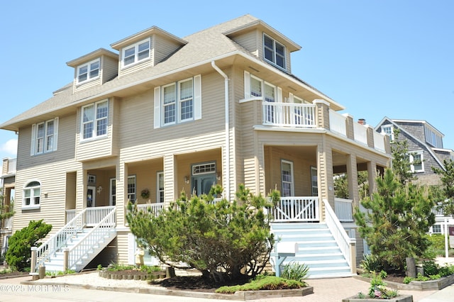 817 S Ocean Ave, Seaside Park, NJ 08752 - view of front facade featuring covered porch, stairway, roof with shingles, and a balcony