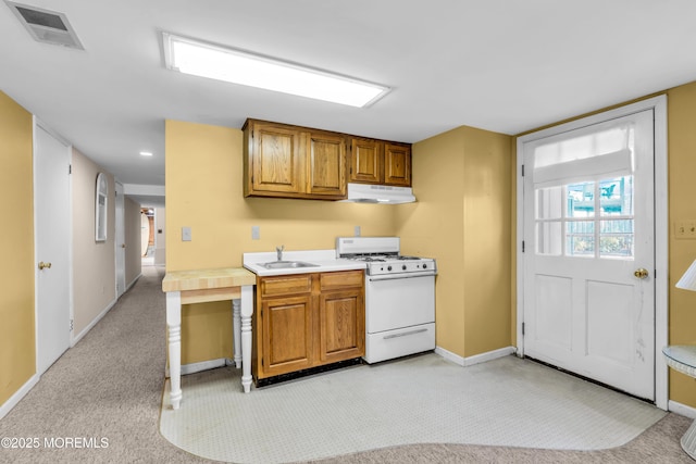 817 S Ocean Ave, Seaside Park, NJ 08752 - kitchen featuring gas range gas stove, under cabinet range hood, light countertops, a sink, and baseboards