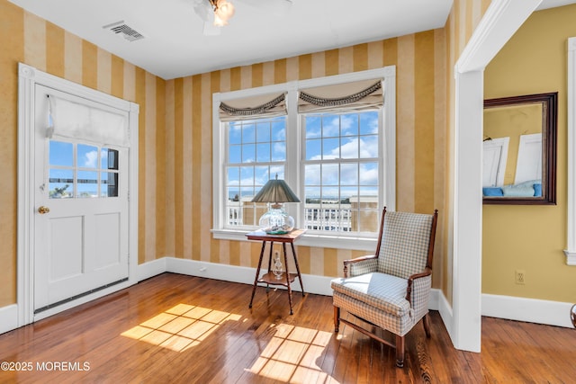 817 S Ocean Ave, Seaside Park, NJ 08752 - living area with plenty of natural light, hardwood / wood-style flooring, wallpapered walls, and baseboards