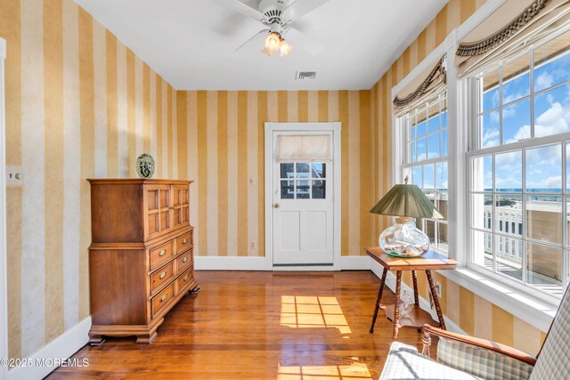 817 S Ocean Ave, Seaside Park, NJ 08752 - living area featuring hardwood / wood-style floors, baseboards, wallpapered walls, and a ceiling fan