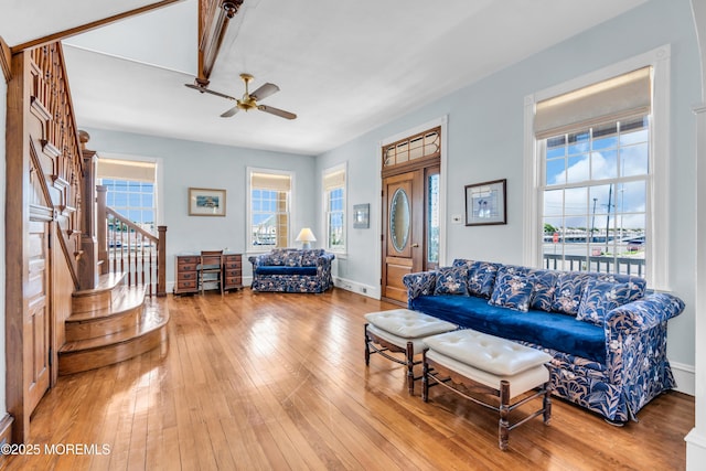 817 S Ocean Ave, Seaside Park, NJ 08752 - living room featuring a ceiling fan, stairway, light wood finished floors, and baseboards