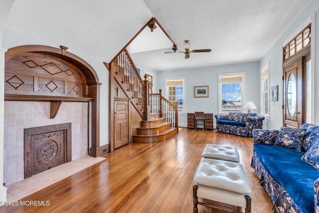 817 S Ocean Ave, Seaside Park, NJ 08752 - living room with ceiling fan, wood-type flooring, stairs, a tiled fireplace, and baseboards