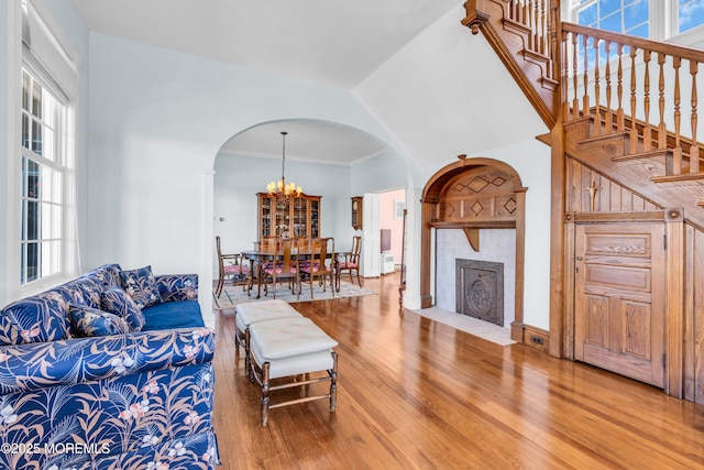 817 S Ocean Ave, Seaside Park, NJ 08752 - living area featuring arched walkways, hardwood / wood-style flooring, a chandelier, healthy amount of natural light, and vaulted ceiling