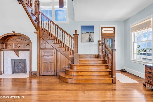 817 S Ocean Ave, Seaside Park, NJ 08752 - stairs with hardwood / wood-style floors, a tiled fireplace, and baseboards