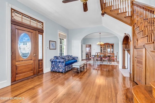 817 S Ocean Ave, Seaside Park, NJ 08752 - entryway with arched walkways, light wood-style floors, a ceiling fan, a chandelier, and stairs