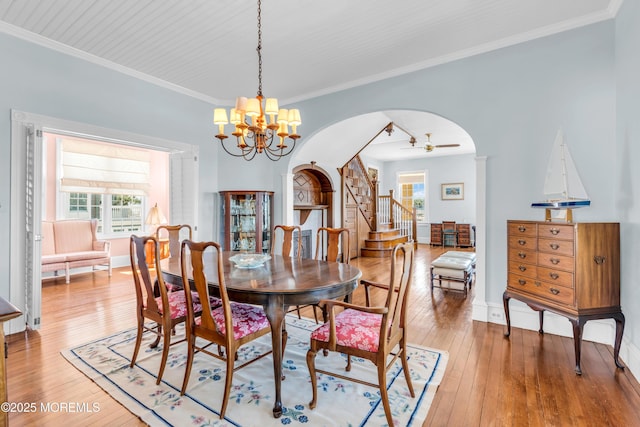817 S Ocean Ave, Seaside Park, NJ 08752 - dining room with a chandelier, arched walkways, light wood-type flooring, ornamental molding, and stairs