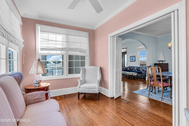 817 S Ocean Ave, Seaside Park, NJ 08752 - living area with wood finished floors, ceiling fan, arched walkways, crown molding, and baseboards