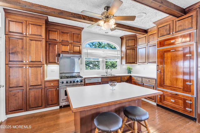 817 S Ocean Ave, Seaside Park, NJ 08752 - kitchen featuring luxury range, a sink, beam ceiling, wood finished floors, and a textured ceiling