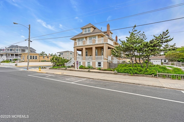 817 S Ocean Ave, Seaside Park, NJ 08752 - view of front of home with a balcony, covered porch, a chimney, and stairway