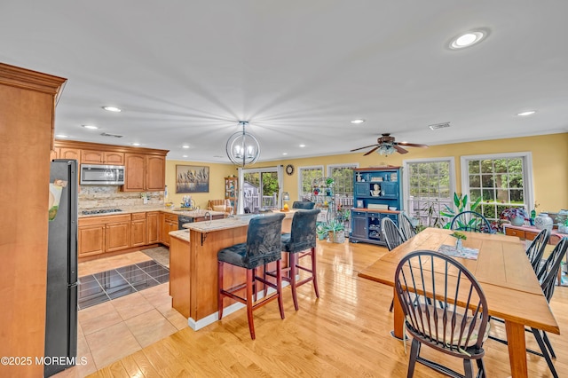 255 Cherokee Trl, Forked River, NJ 08731 - kitchen with black appliances, recessed lighting, a breakfast bar, healthy amount of natural light, and light countertops