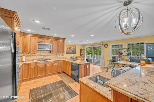 255 Cherokee Trl, Forked River, NJ 08731 - kitchen with black appliances, a sink, a chandelier, light stone countertops, and backsplash
