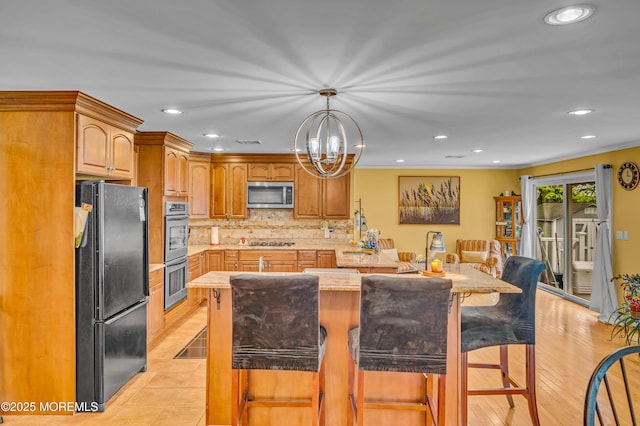 255 Cherokee Trl, Forked River, NJ 08731 - kitchen with stainless steel appliances, a kitchen bar, a chandelier, decorative backsplash, and recessed lighting