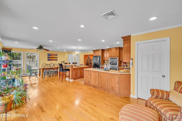 255 Cherokee Trl, Forked River, NJ 08731 - kitchen with freestanding refrigerator, a peninsula, stainless steel double oven, crown molding, and recessed lighting