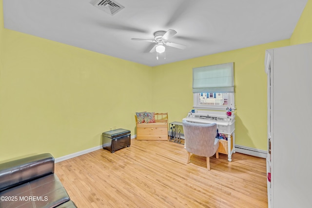 255 Cherokee Trl, Forked River, NJ 08731 - home office featuring a baseboard heating unit, a baseboard radiator, a ceiling fan, wood finished floors, and baseboards