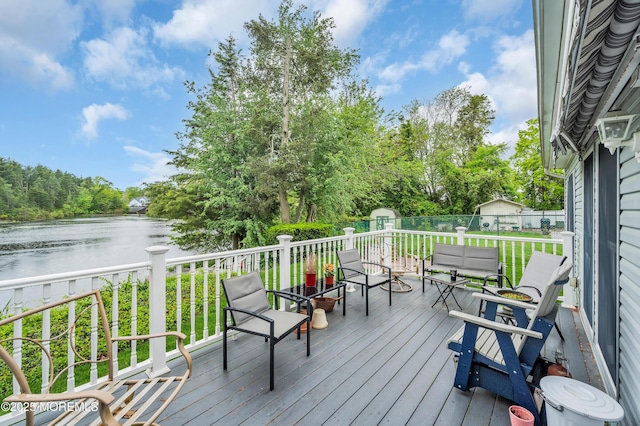 255 Cherokee Trl, Forked River, NJ 08731 - wooden deck featuring a shed, a water view, an outdoor structure, a fenced backyard, and view of wooded area