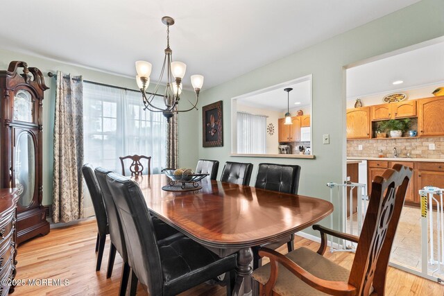 dining space featuring a chandelier and light wood-style floors