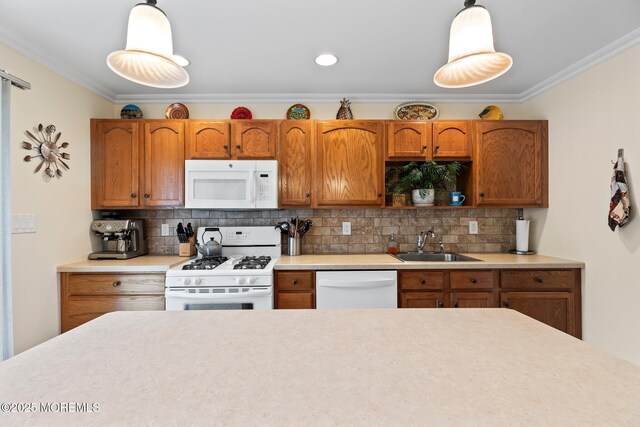kitchen with white appliances, a sink, crown molding, light countertops, and backsplash