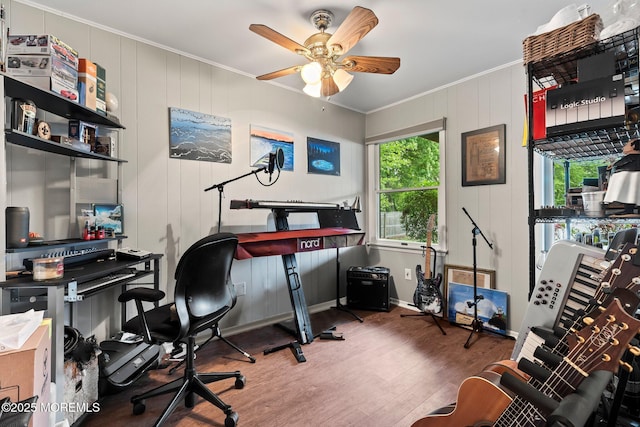 bedroom with crown molding, wood finished floors, baseboards, and ceiling fan
