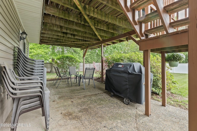 view of patio with outdoor dining space, a fenced backyard, and area for grilling
