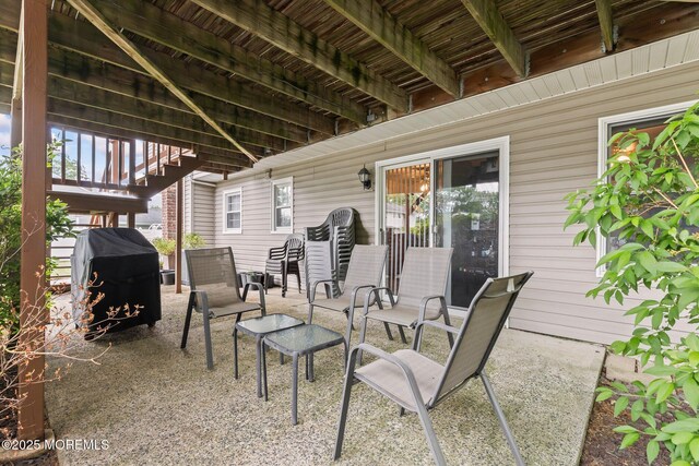 view of patio featuring area for grilling and stairway