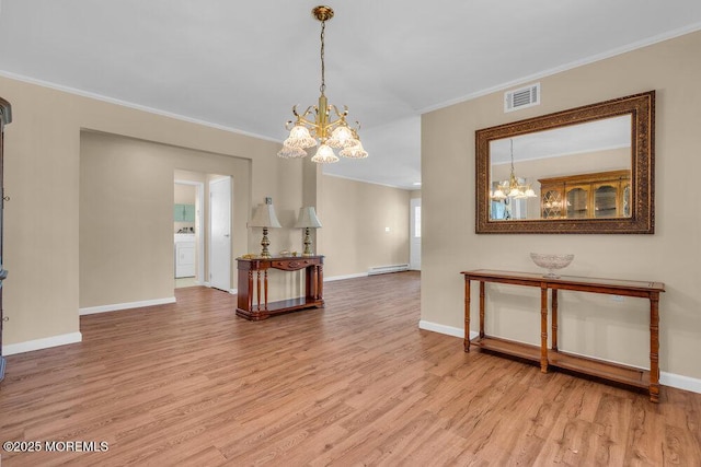 25 Elmswell Ave, Manchester, NJ 08759 - living area featuring a chandelier, wood finished floors, baseboards, crown molding, and baseboard heating