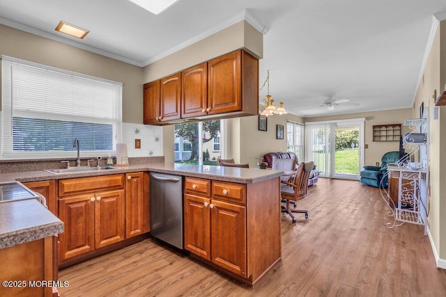 25 Elmswell Ave, Manchester, NJ 08759 - kitchen with stainless steel dishwasher, open floor plan, a sink, brown cabinetry, and crown molding