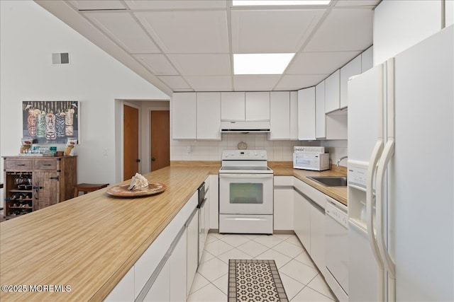 77 E Water St Unit 18, Toms River, NJ 08753 - kitchen with white appliances, under cabinet range hood, light countertops, a sink, and white cabinets