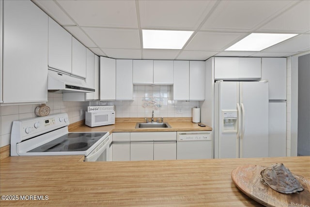 77 E Water St Unit 18, Toms River, NJ 08753 - kitchen with under cabinet range hood, white appliances, a sink, backsplash, and white cabinets