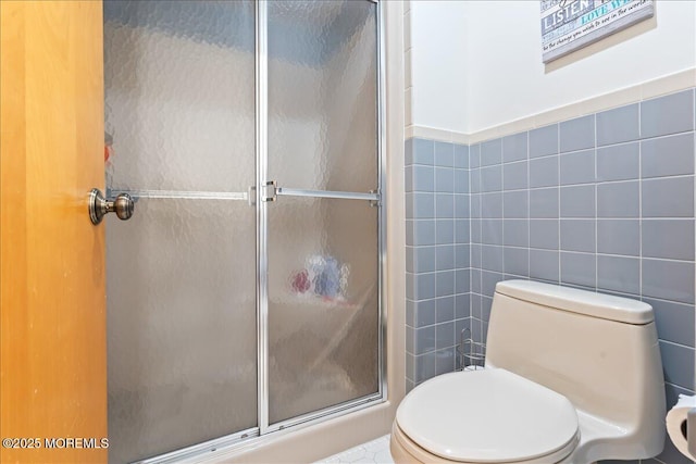 77 E Water St Unit 18, Toms River, NJ 08753 - bathroom with tile walls, a shower stall, and toilet