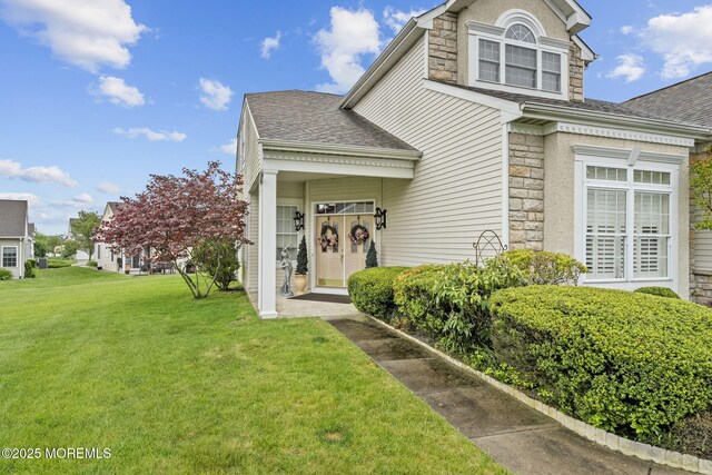 5 Chadwick Ct, Waretown, NJ 08758 - view of front facade featuring stone siding, a front lawn, and a shingled roof
