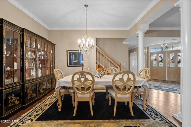 5 Chadwick Ct, Waretown, NJ 08758 - dining area featuring a chandelier, wood-type flooring, crown molding, decorative columns, and stairs