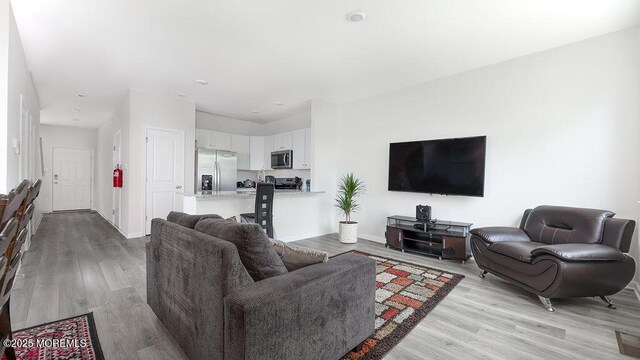 1214 Peterson Way, Abescon, NJ 08201 - living room with light wood-style flooring and baseboards