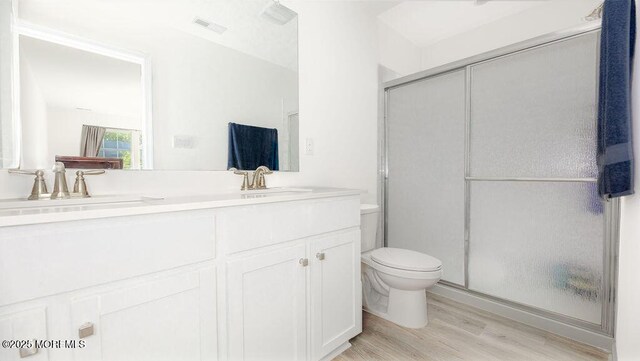 1214 Peterson Way, Abescon, NJ 08201 - full bathroom with wood finished floors, toilet, double vanity, and a shower stall