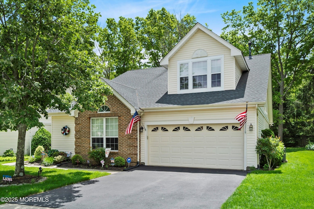 102 Sylvan Lake Blvd, Bayville, NJ 08721 - traditional home with driveway, a shingled roof, a front lawn, and brick siding
