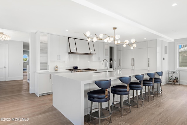 948 Lagoon Ln S, Mantoloking, NJ 08738 - kitchen with light wood-style floors, a chandelier, light countertops, a large island with sink, and recessed lighting