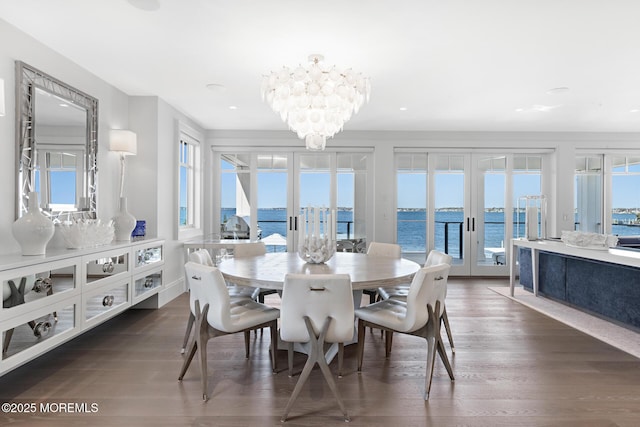 948 Lagoon Ln S, Mantoloking, NJ 08738 - dining area with french doors, wood finished floors, a chandelier, and a water view