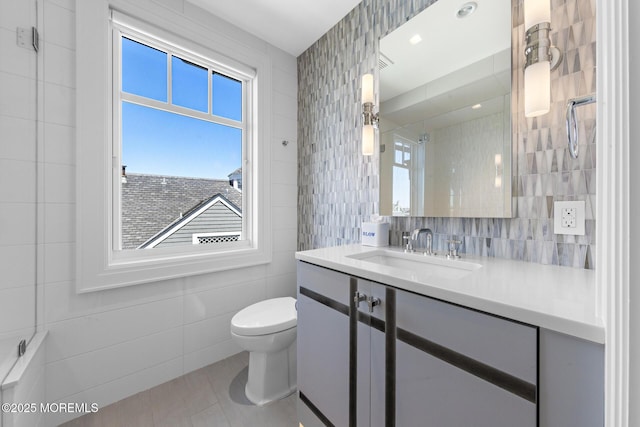 948 Lagoon Ln S, Mantoloking, NJ 08738 - full bathroom with tile walls, toilet, vanity, tile patterned floors, and tasteful backsplash