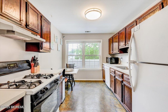 82 Briarwood Ct, Howell, NJ 07731 - kitchen featuring white appliances, under cabinet range hood, light countertops, baseboards, and a sink