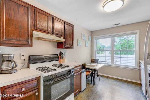 82 Briarwood Ct, Howell, NJ 07731 - kitchen featuring range with gas cooktop, under cabinet range hood, baseboards, and light countertops