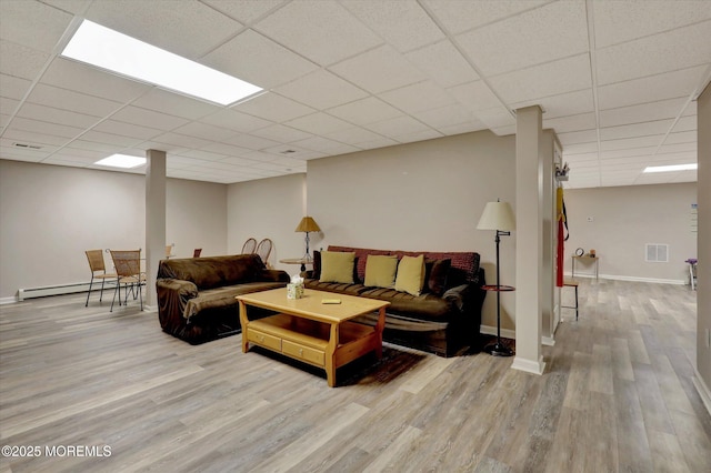 50 Hedgerow Ln, Manalapan, NJ 07726 - living room with wood finished floors, a paneled ceiling, a baseboard heating unit, and baseboards